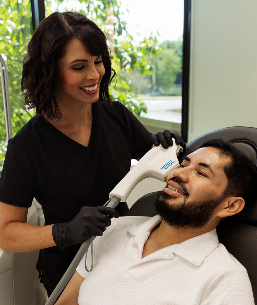 Photo of a man getting BBL® HERO™ treatments at Synergi MedSpa