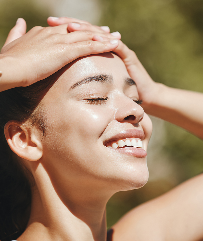 Photo of a smiling woman's face in the sunlight